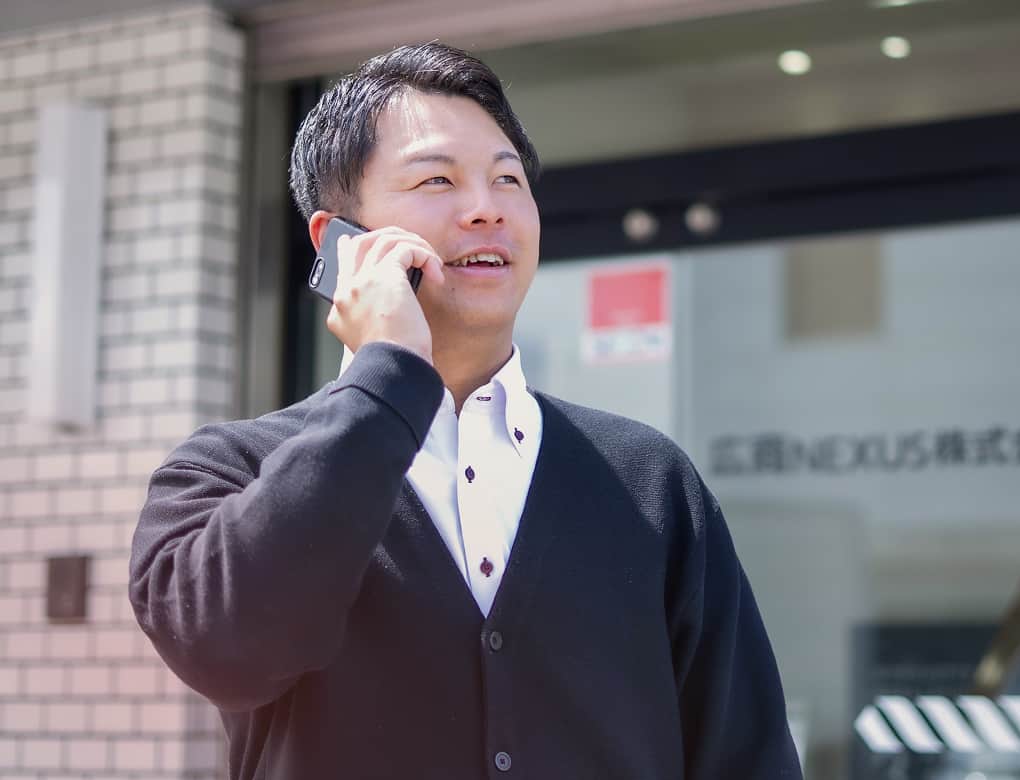 スマートフォンで通話する営業職の社員